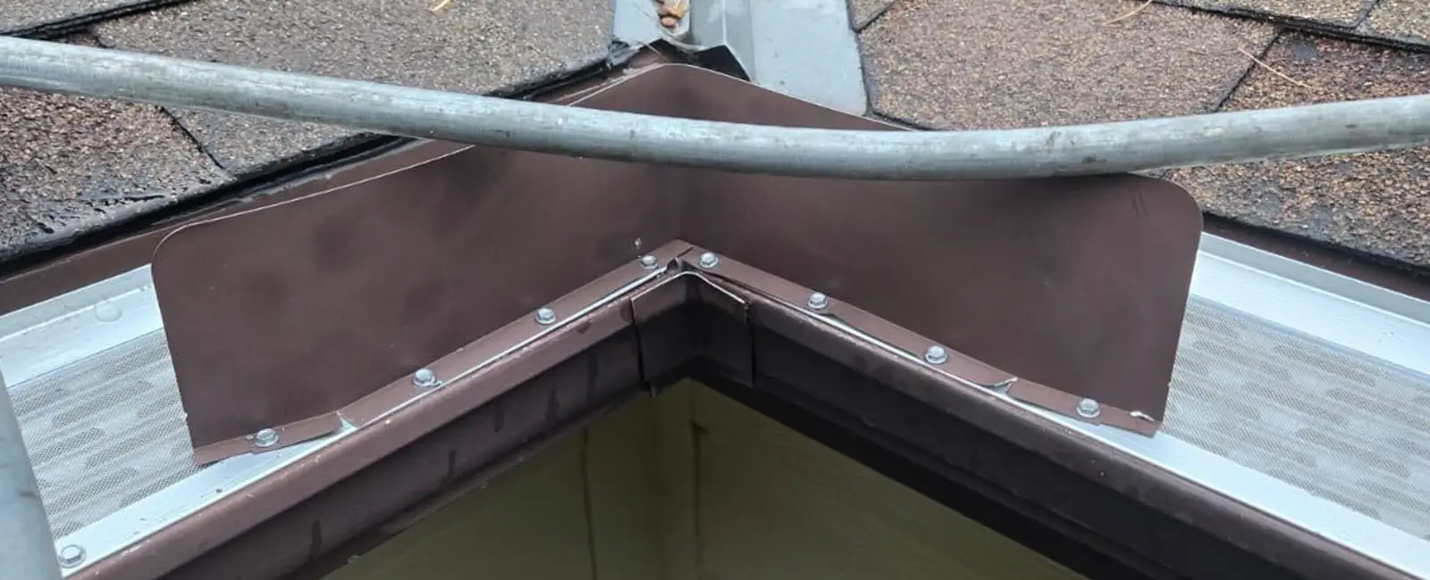 Professional gutter installation with downspout